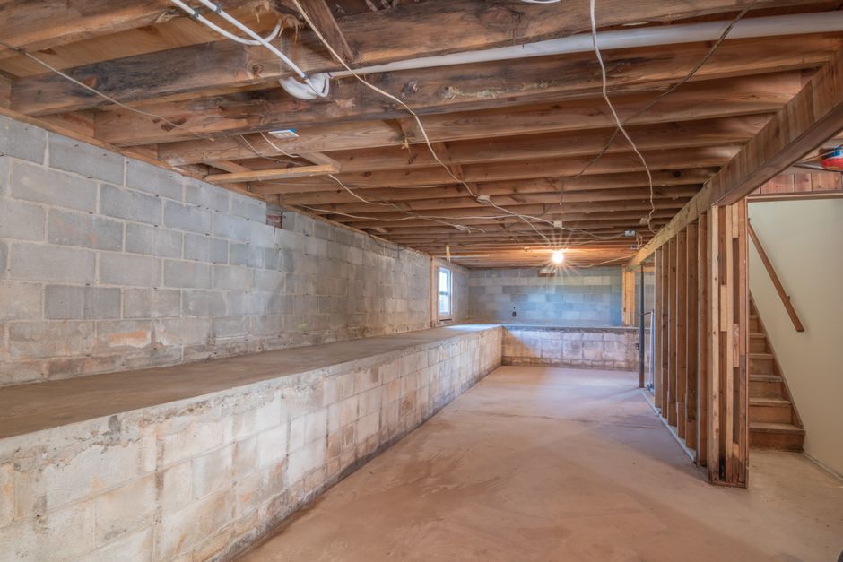 Basement waterproofing work on a foundation wall